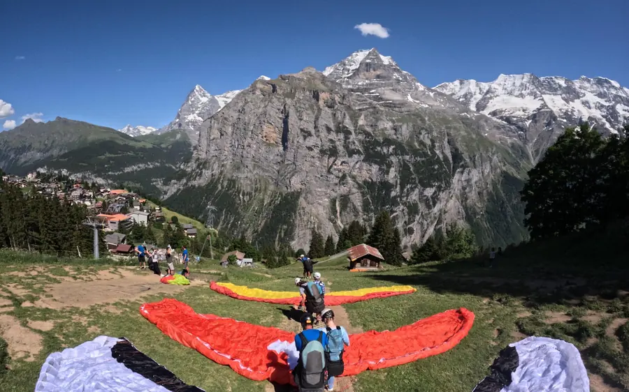 A tandem paraglider above the cliffs and waterfalls of the Lauterbrunnen valley