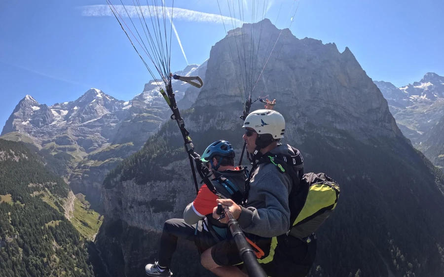 A tandem paraglider high above M&uuml;rren and the Lauterbrunnen valley