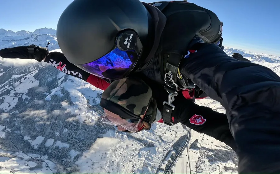 A tandem skydiver in freefall above the Swiss Alps near Interlaken